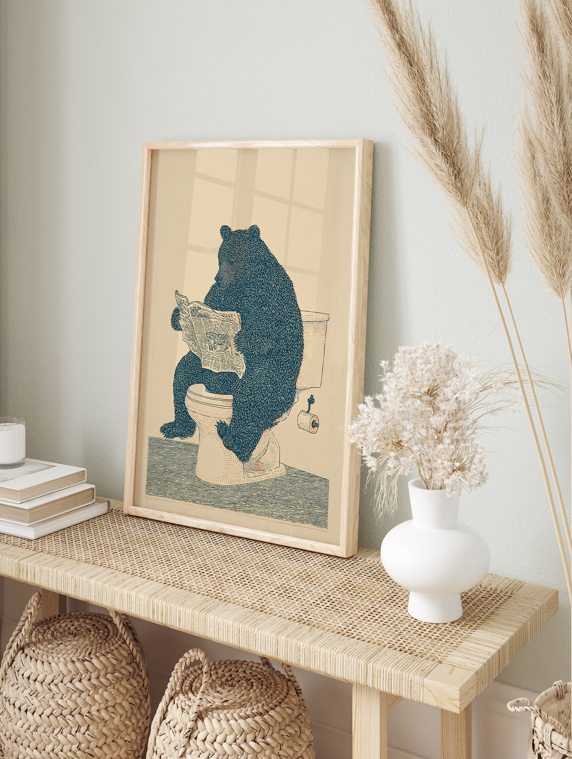 Humorous illustration of a large, dark blue bear sitting on a white toilet, reading a newspaper, on a light beige background. - Image 3
