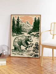 Vintage style illustration of a bear catching a fish in a river with pine trees, mountains, and an orange sky. Bear wall art. - Image 2