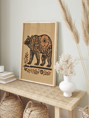 Stylised bear wall art print with botanical patterns in dark brown and beige on a sandy, in an alternate framed mockup