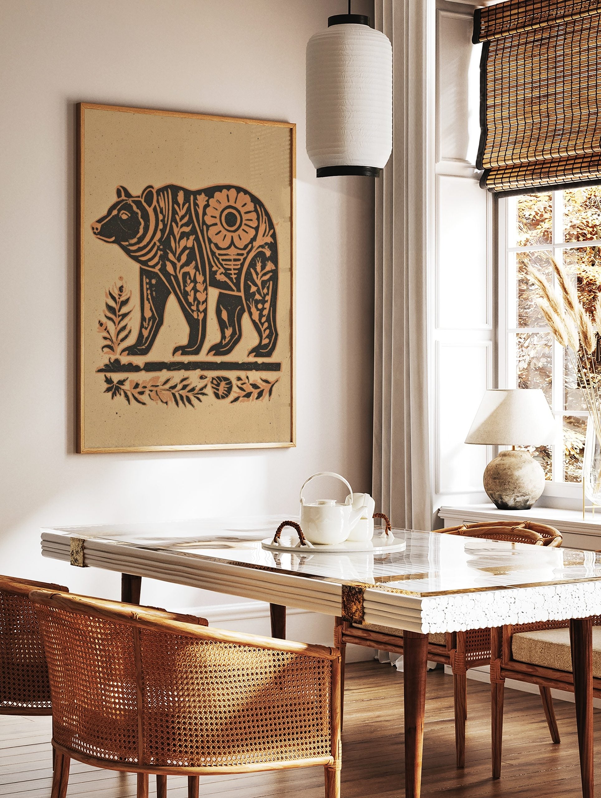 Stylised bear wall art print with botanical patterns in dark brown and beige on a sandy background, in a styled room mockup