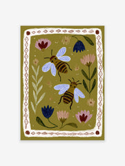 Illustrated bee and floral wall art print on an olive green background with a decorative border.