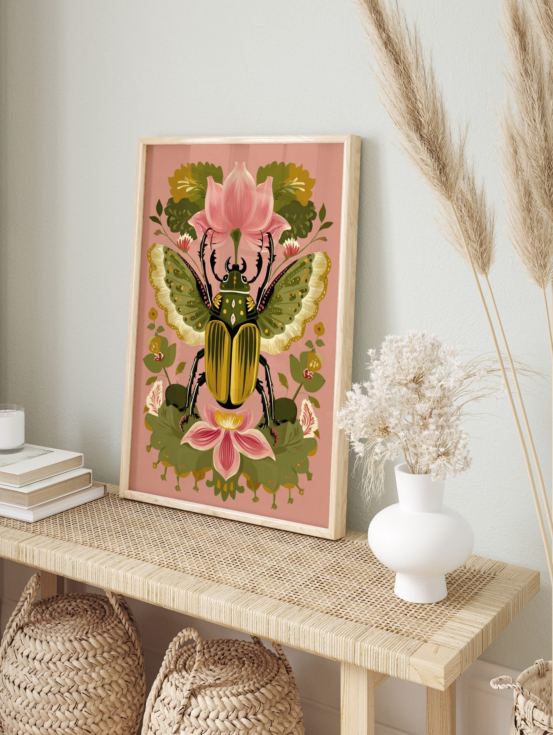 Ornate green and gold beetle with patterned wings, surrounded by pink lotus flowers and green, in an alternate framed mockup