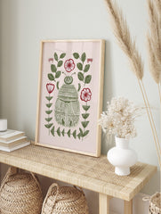 Illustrative green scarab beetle surrounded by green leaves and red-and-white flowers on a, in an alternate framed mockup