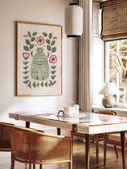 Illustrative green scarab beetle surrounded by green leaves and red-and-white flowers on a light, in a styled room mockup