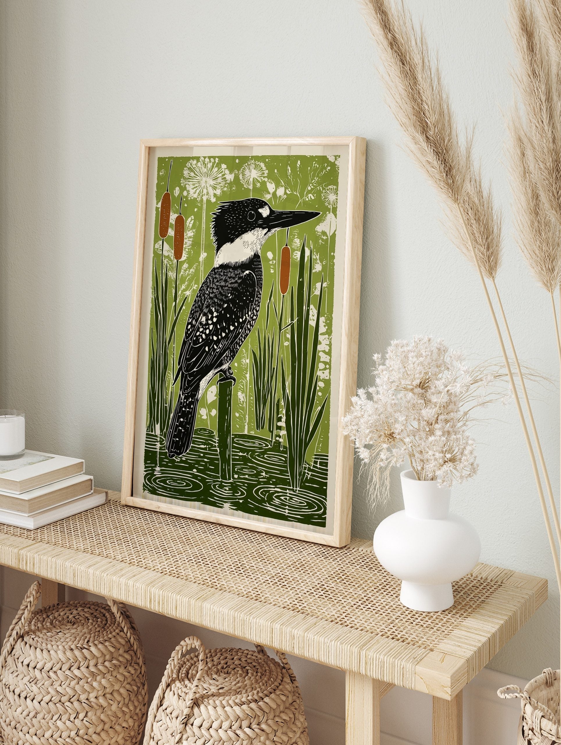 Belted Kingfisher bird perched on a post in a green wetland with cattails and water ripples, in an alternate framed mockup