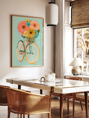 Illustrative bicycle with an orange frame and basket full of colourful flowers on a soft teal, in a styled room mockup