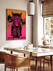 Neon pink and green biker cat poster with aviator goggles, motorcycle, and the text Chase Your, in a styled room mockup