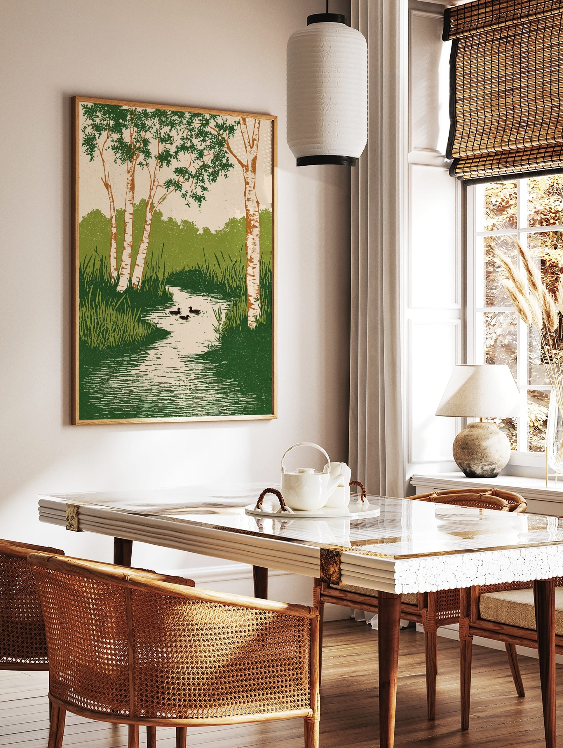 Illustrative wall art of birch trees with green leaves, a winding stream, reeds, and three ducks, in a styled room mockup