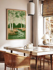 Illustrative print of birch trees, ducks in a river, marsh grass, and flying birds in green and, in a styled room mockup