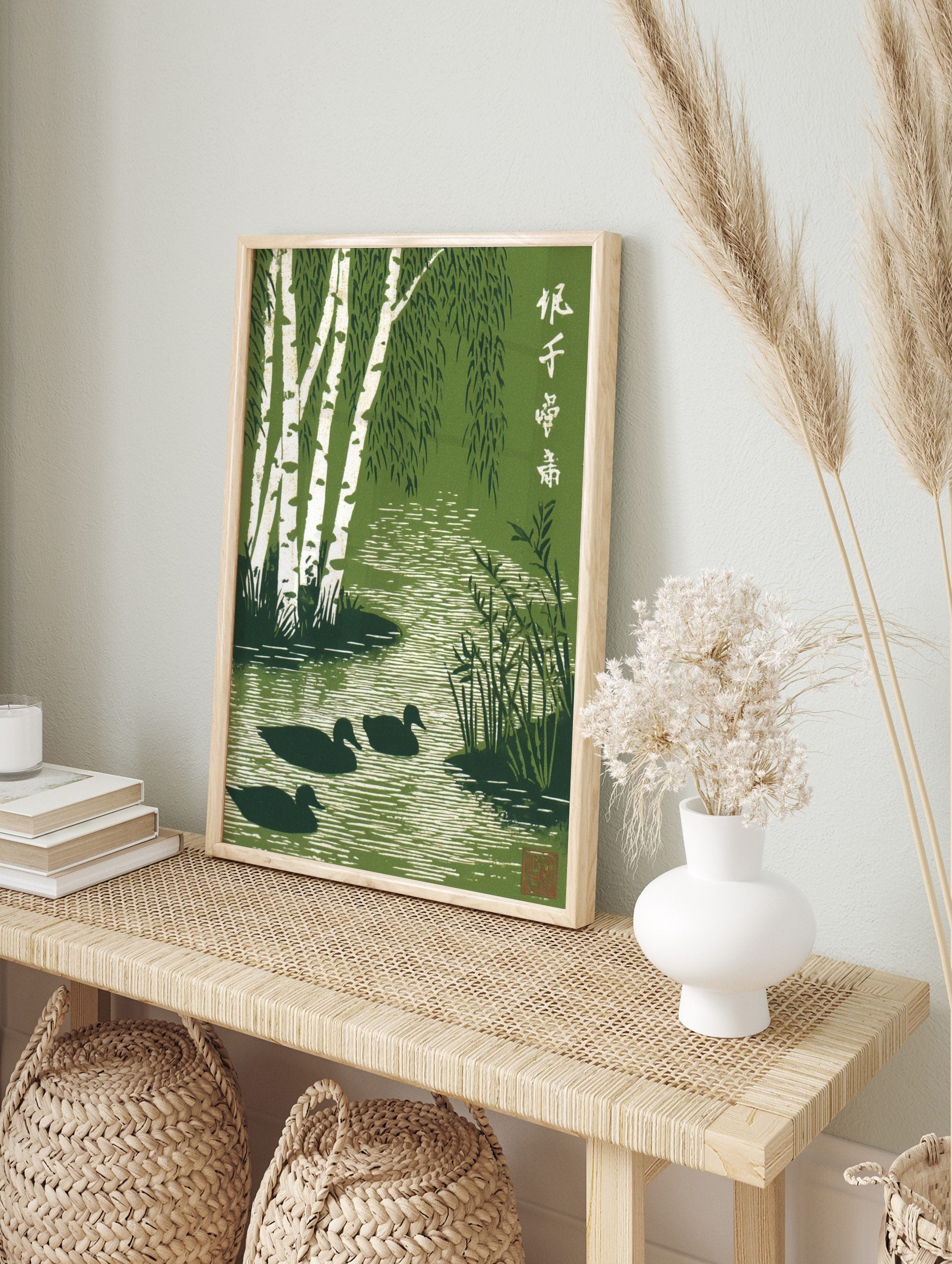 Green woodblock print of white birch trees, weeping leaves, three ducks in a rippling stream, in an alternate framed mockup