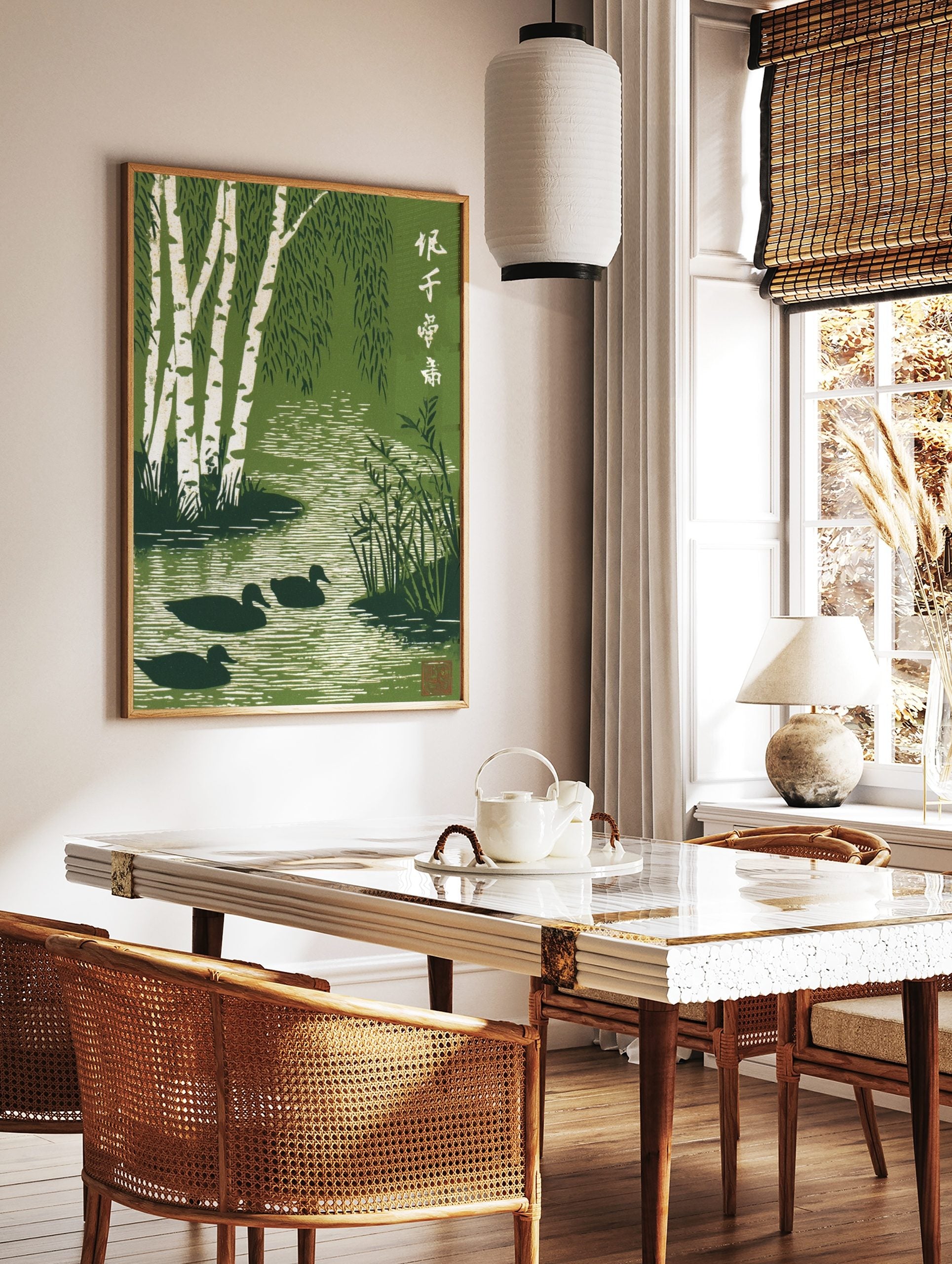 Green woodblock print of white birch trees, weeping leaves, three ducks in a rippling stream, and, in a styled room mockup