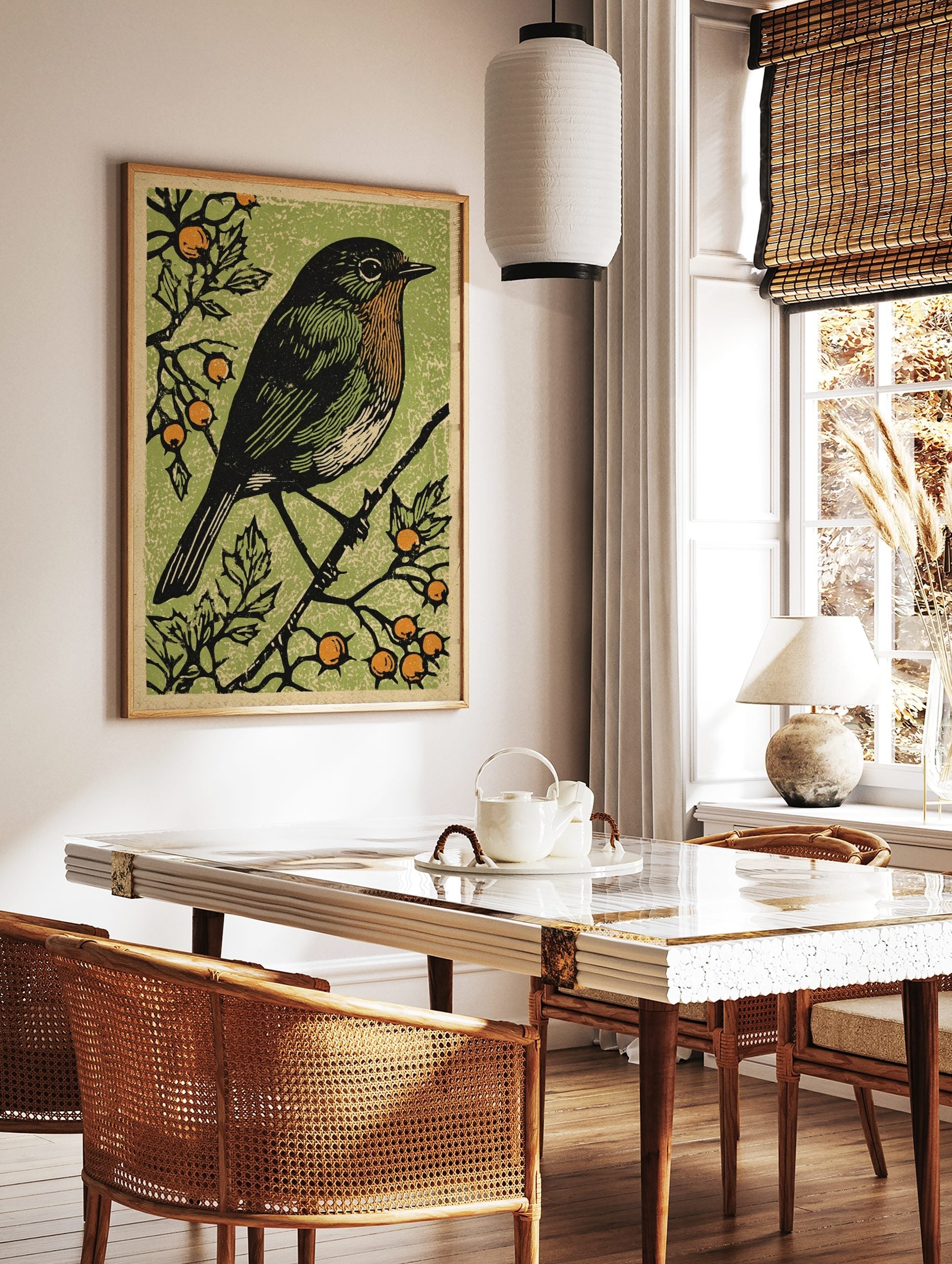 Illustrative black bird with orange breast on a branch with berries against a textured green, in a styled room mockup
