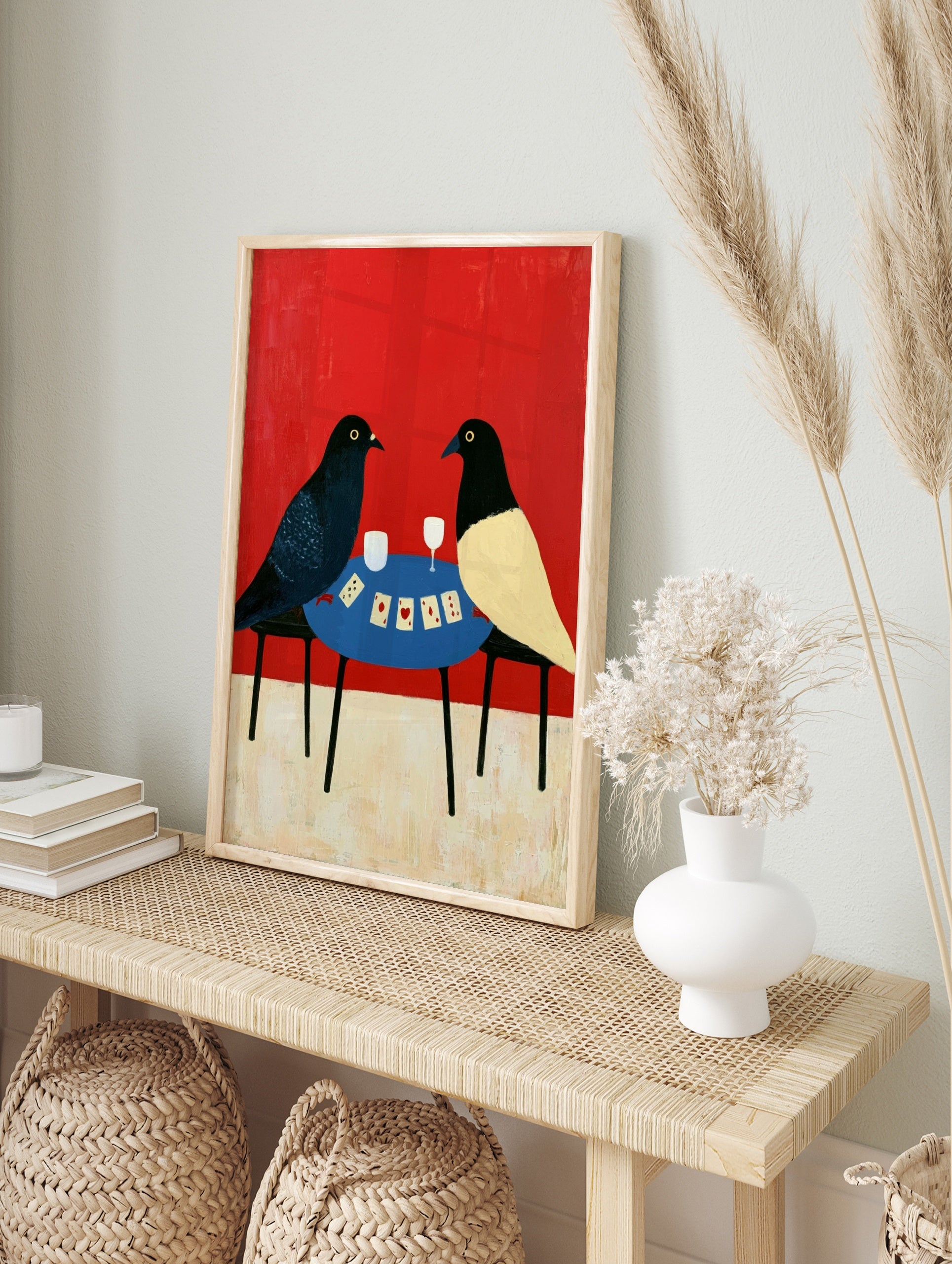 Illustrative art print of two birds playing cards on a blue table against a solid red, in an alternate framed mockup