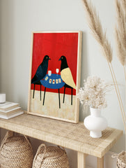 Illustrative art print of two birds playing cards on a blue table against a solid red, in an alternate framed mockup