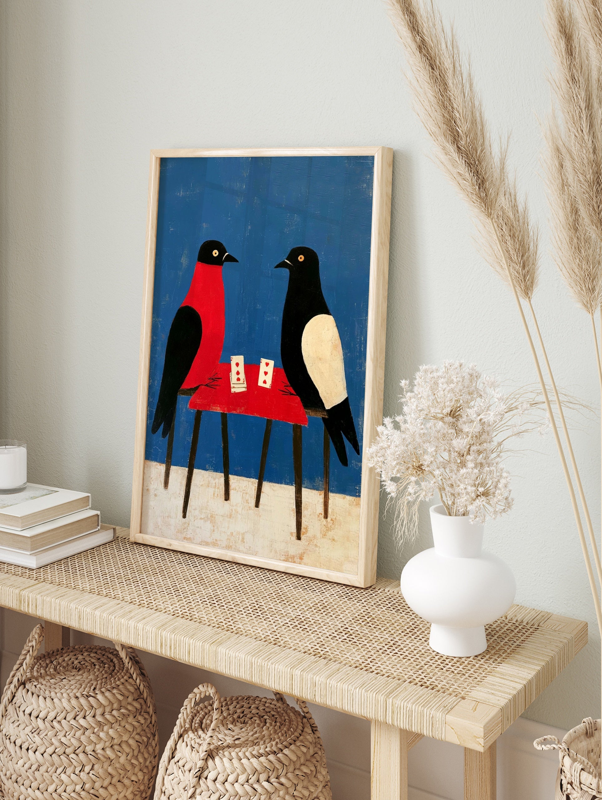 Illustrative art print of two birds playing cards at a red table against a blue background, in an alternate framed mockup
