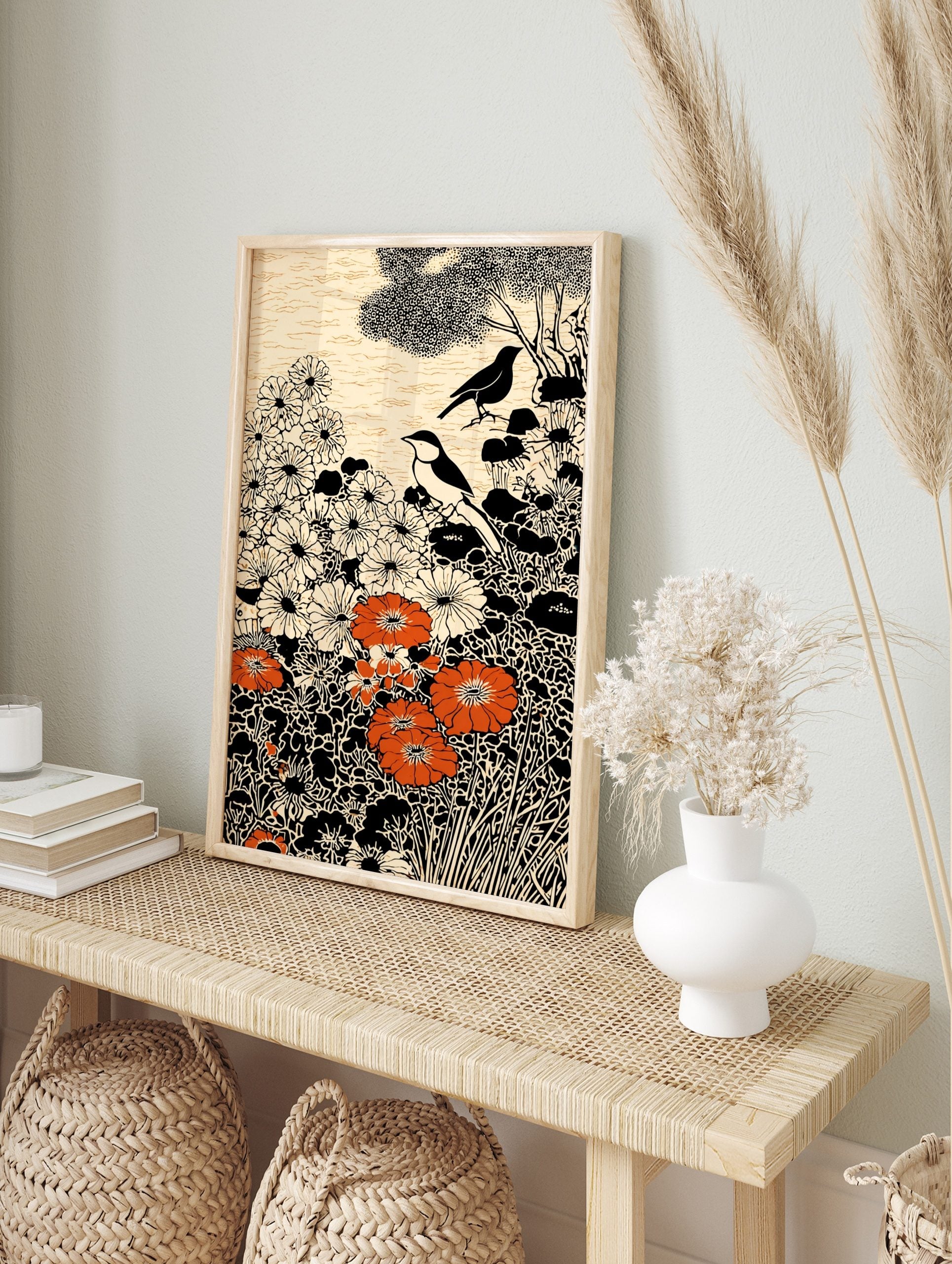 Illustrative art print with two birds, white and orange flowers, black foliage, and cream, in an alternate framed mockup