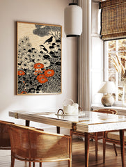 Illustrative art print with two birds, white and orange flowers, black foliage, and cream background, in a styled room mockup