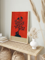 Black silhouette of a tree with three birds on a vibrant reddish-orange background, with a, in an alternate framed mockup