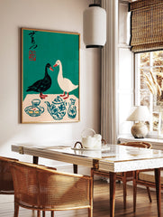 Illustrative print of black and white ducks with a blue patterned teapot and Japanese calligraphy, in a styled room mockup