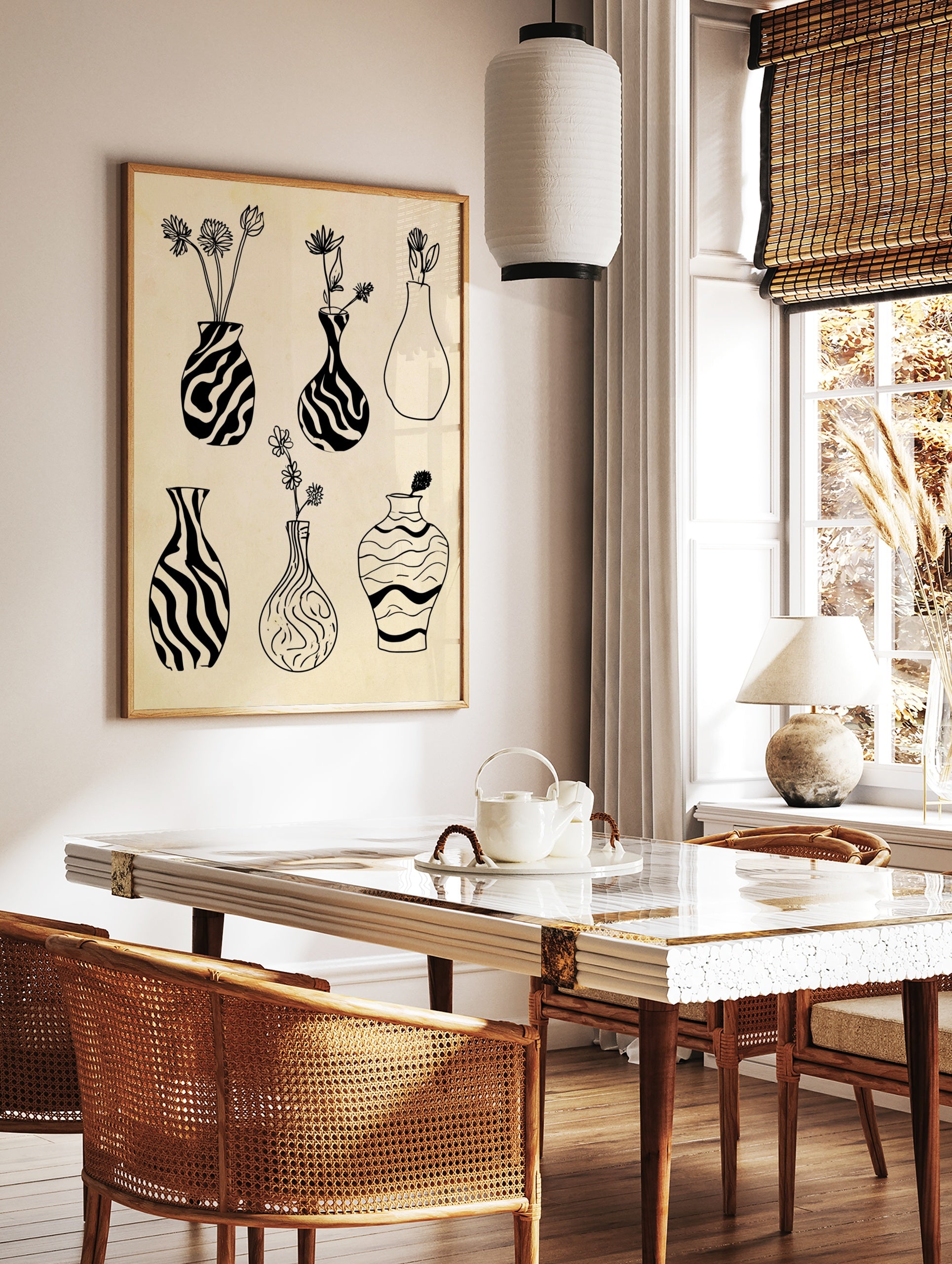 Black and white line art print featuring six illustrative vases with botanical elements on a, in a styled room mockup