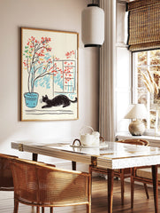 Illustrative print of a black cat lounging next to a potted plant with red, yellow, green leaves by, in a styled room mockup