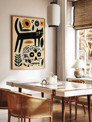 Black cat standing on a floral patterned skull with orange and blue botanical elements on a beige, in a styled room mockup