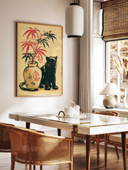 Japanese-inspired illustration of a black cat next to a vase with red and black bamboo leaves on, in a styled room mockup