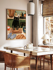 Illustration of a black cat wearing oven mitts kneading a loaf of bread on a wooden board in a, in a styled room mockup