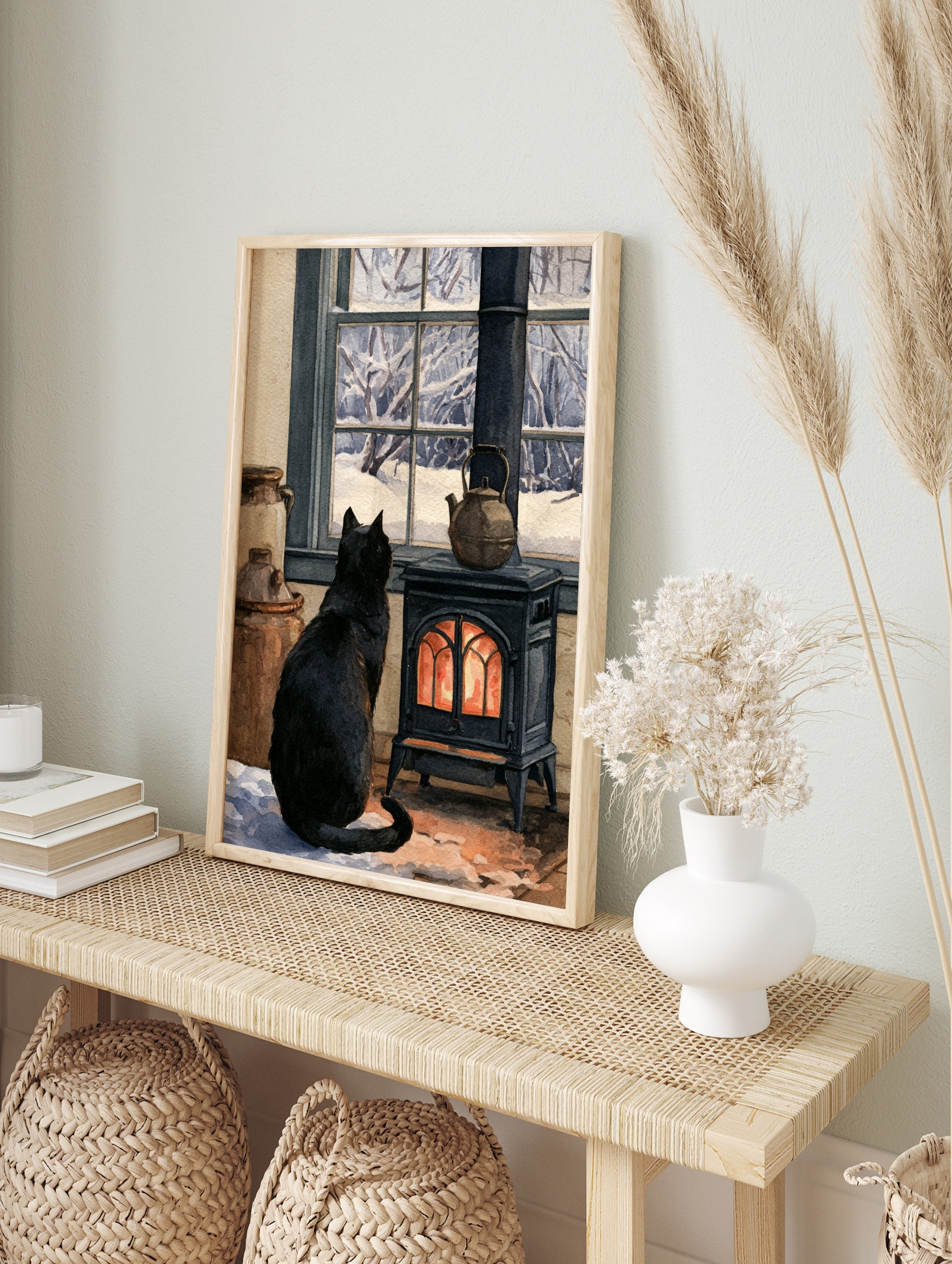 Black cat sitting before a glowing cast-iron stove, looking out a window at a snowy forest, in an alternate framed mockup