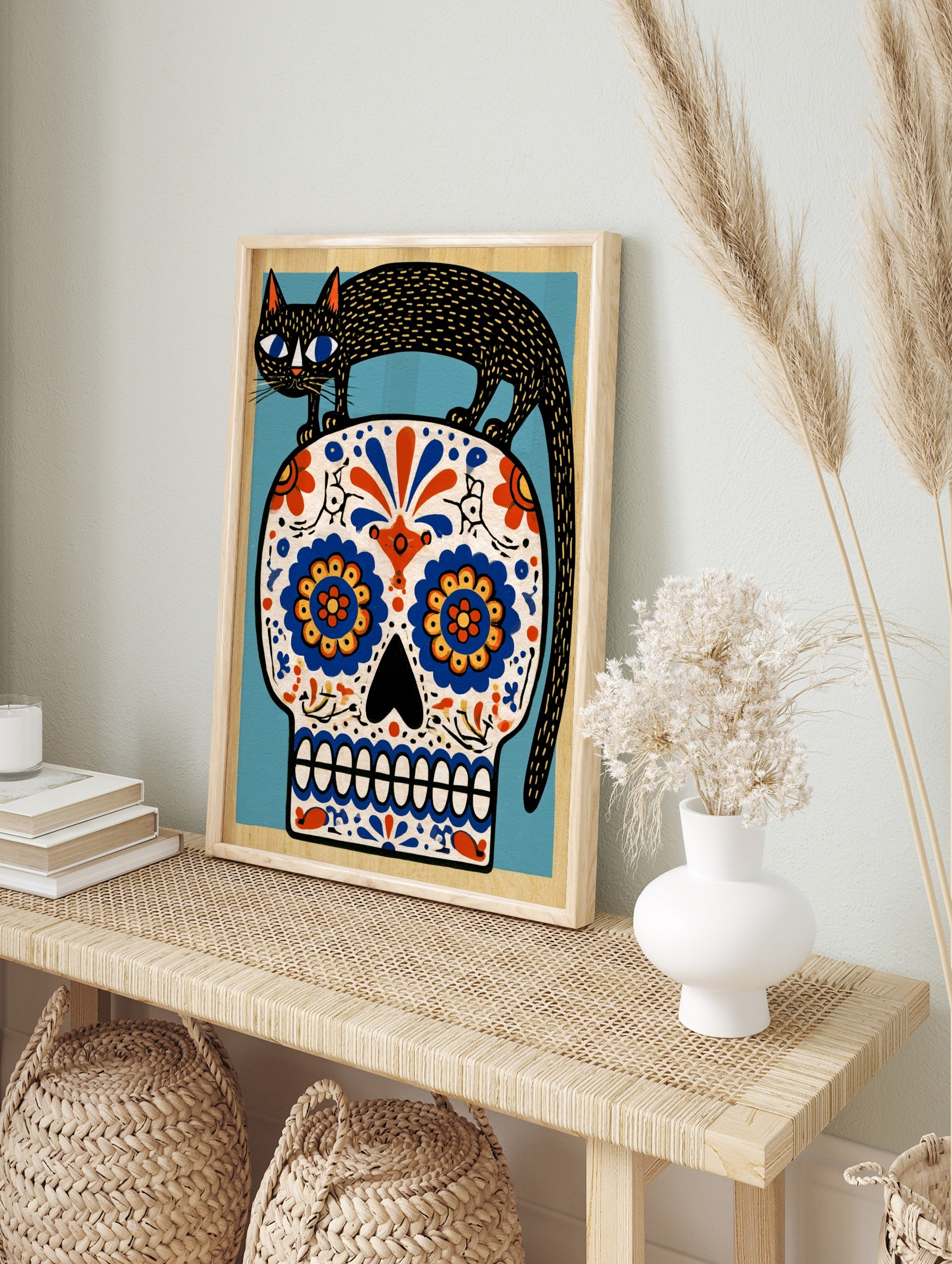 Black cat standing on a decorative sugar skull with vibrant blue and orange floral patterns, in an alternate framed mockup