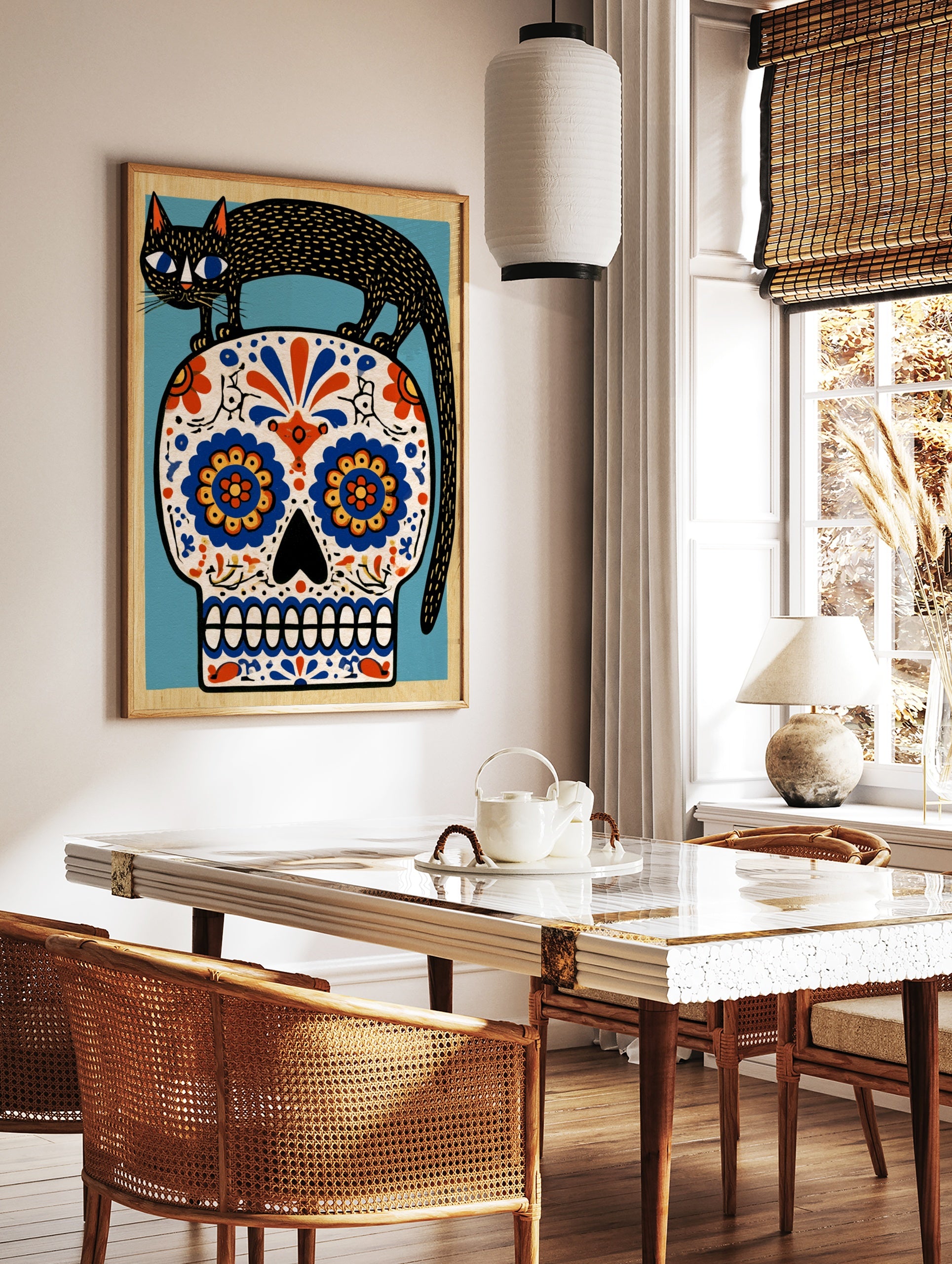 Black cat standing on a decorative sugar skull with vibrant blue and orange floral patterns, in a styled room mockup