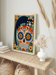 Illustrative Day of the Dead skull with a black cat on top and colourful floral patterns on a, in an alternate framed mockup