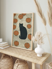 Black cat with green eyes sitting among orange Japanese lanterns on a textured background, in an alternate framed mockup