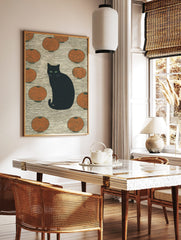 Black cat with green eyes sitting among orange Japanese lanterns on a textured background, in a styled room mockup