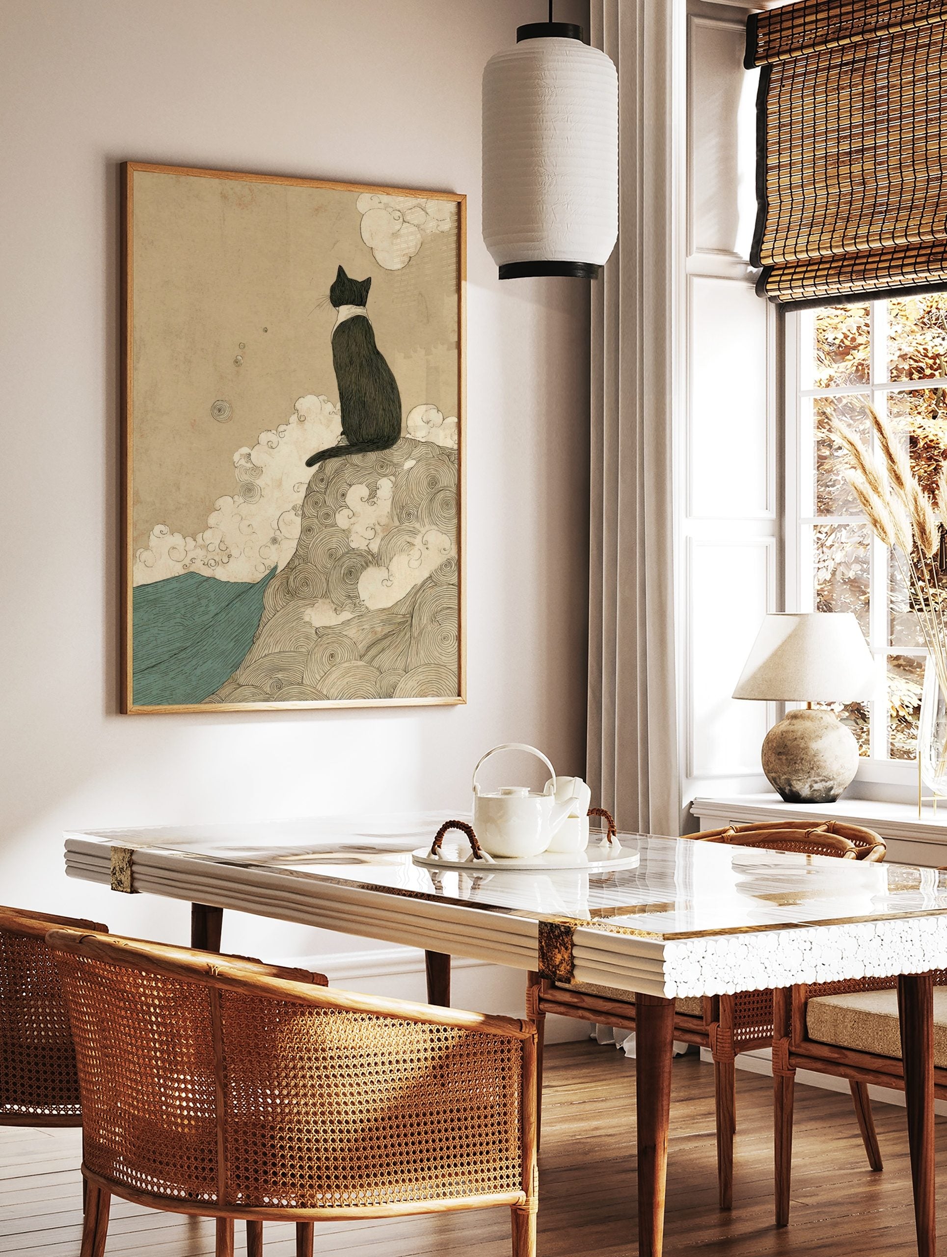 Japanese style black cat print, sitting on swirling mound, gazing over teal waves under beige sky, in a styled room mockup