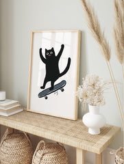 Black cat illustration on a skateboard with arms raised in excitement on a white background. Playful cat wall art. - Image 3