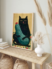 Stylized black cat holding a green zucchini with a red flower on a tan background, in an alternate framed mockup