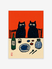 Illustrative print of two black cats at a dinner table with fish, sake, and a vase, against an orange background
