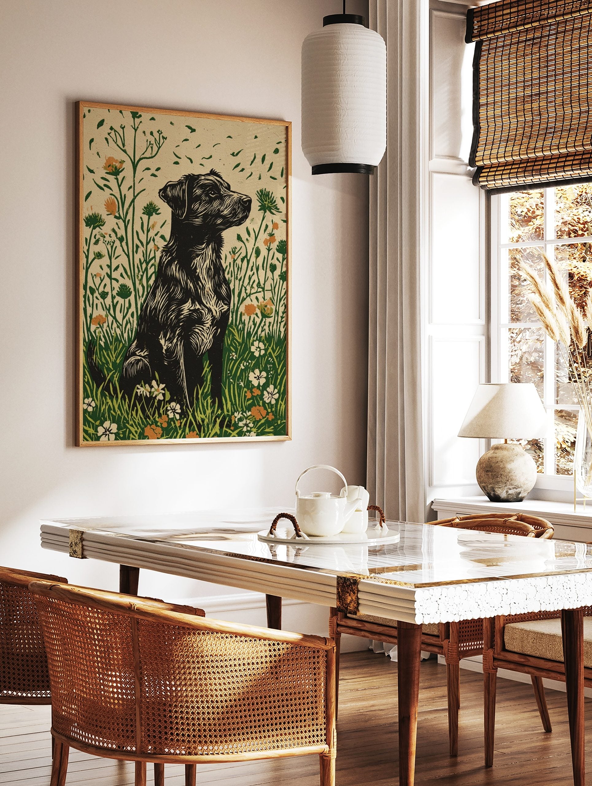 Black shaggy dog in linocut style sitting in a green and orange wildflower meadow art print, in a styled room mockup