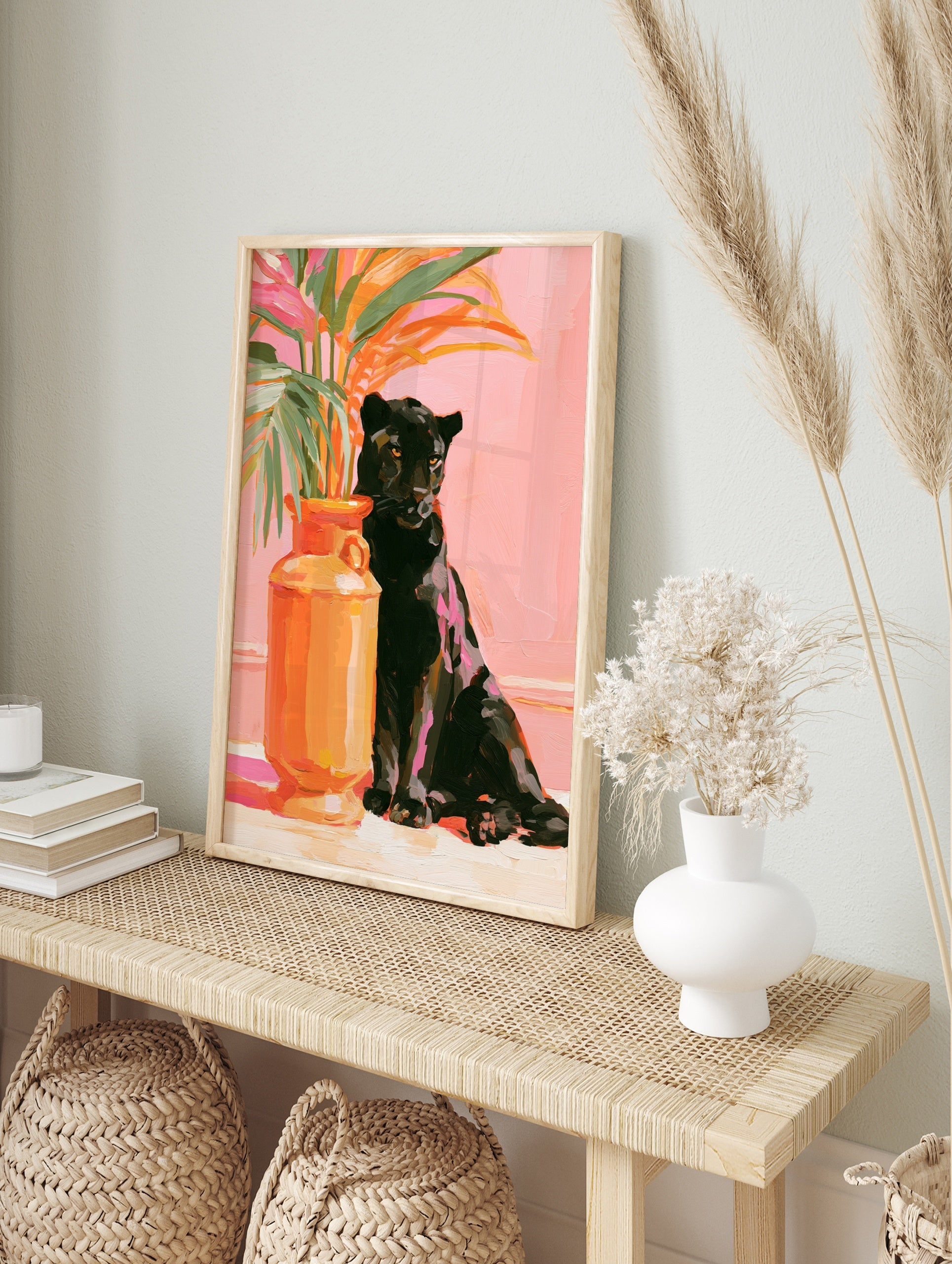 Painterly art print of a black panther sitting next to an orange vase with tropical leaves, in an alternate framed mockup