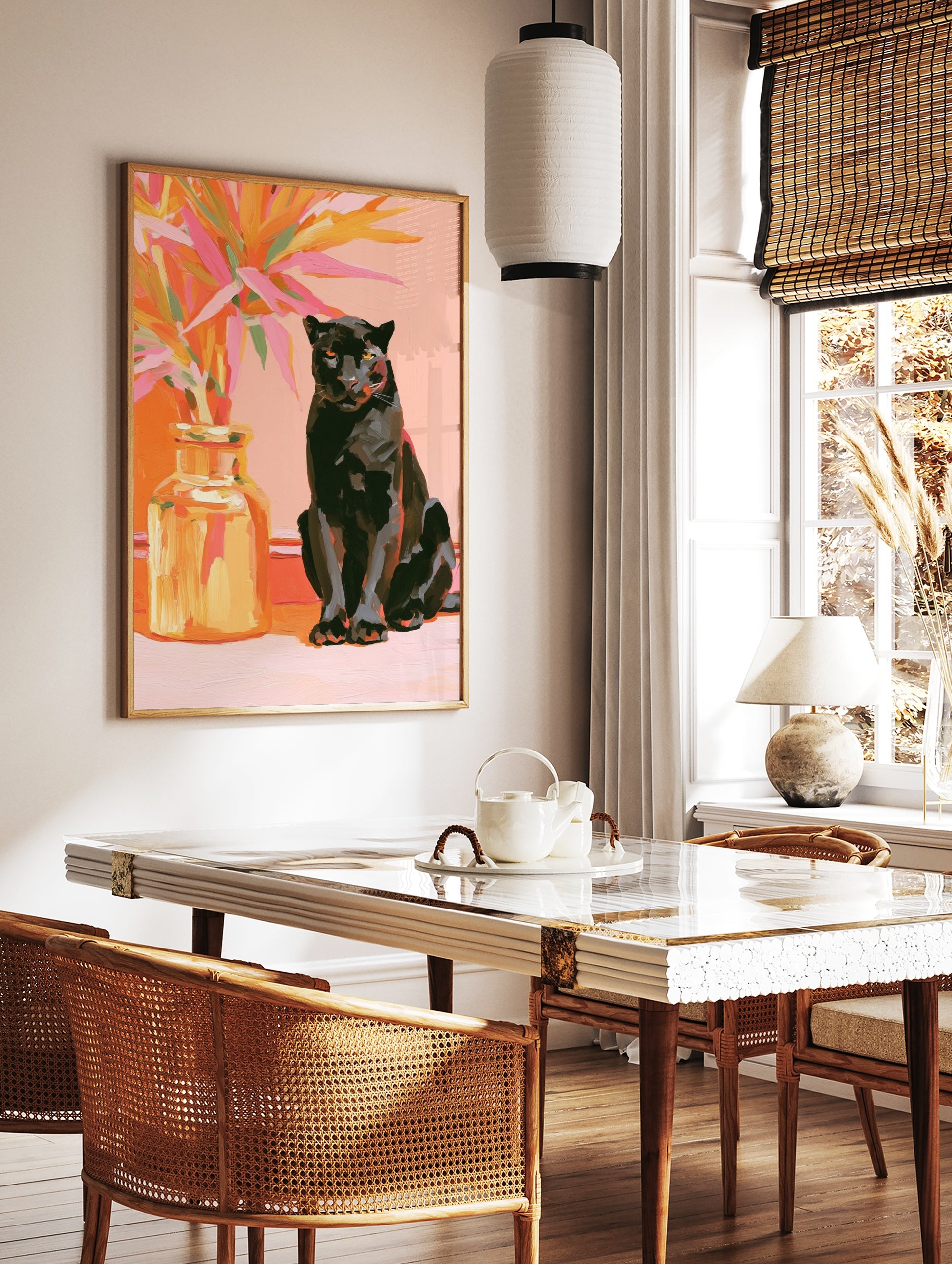 Black panther sitting beside a vase of vibrant orange and pink tropical leaves on a pink, in a styled room mockup