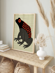 Black and red frog poster with stylized body, red polka dots, and vertical stripes, on a light beige striped background. - Image 4