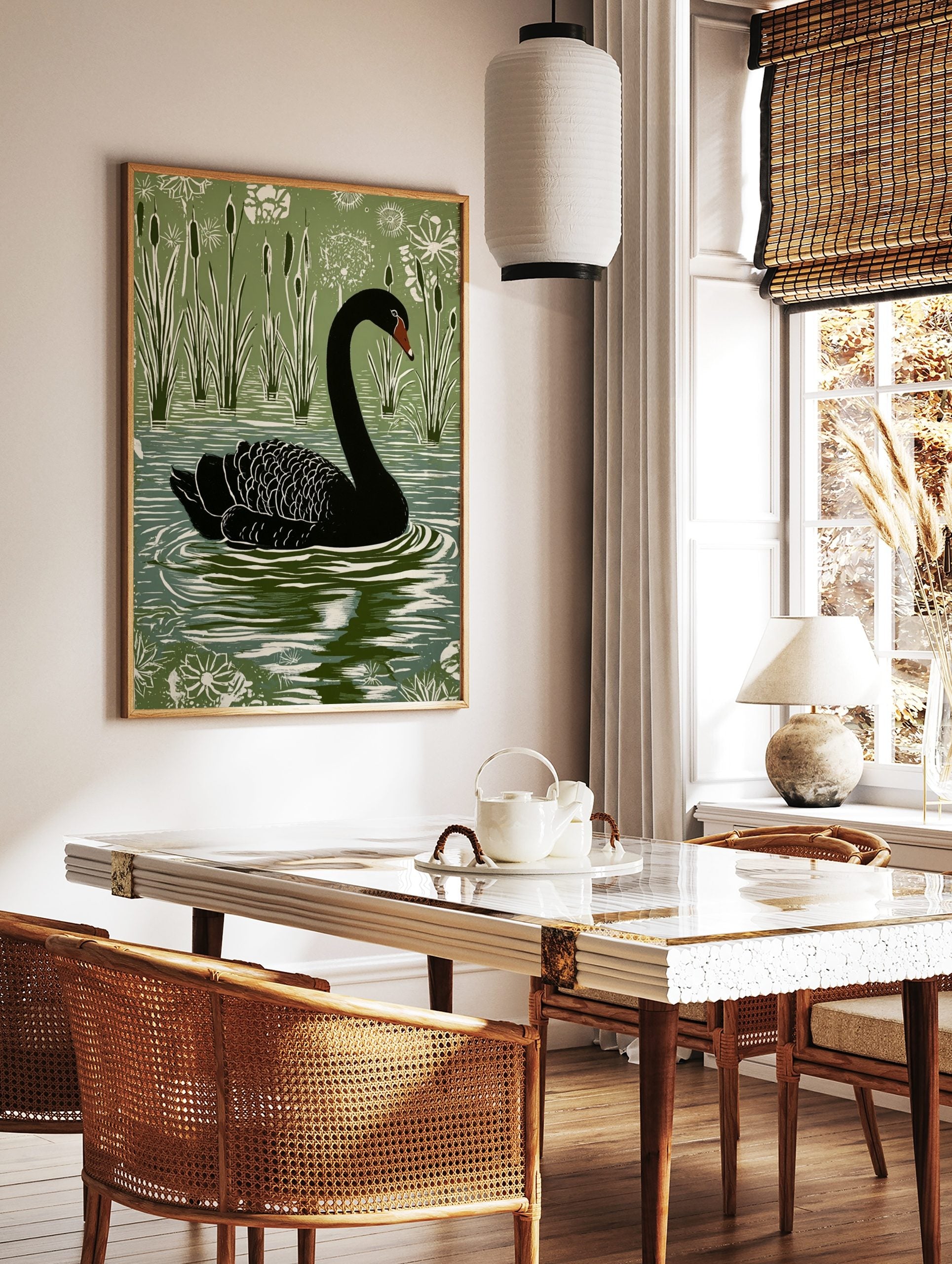 Black swan with red beak swimming in water with green cattails and white plants, in a linocut style, in a styled room mockup