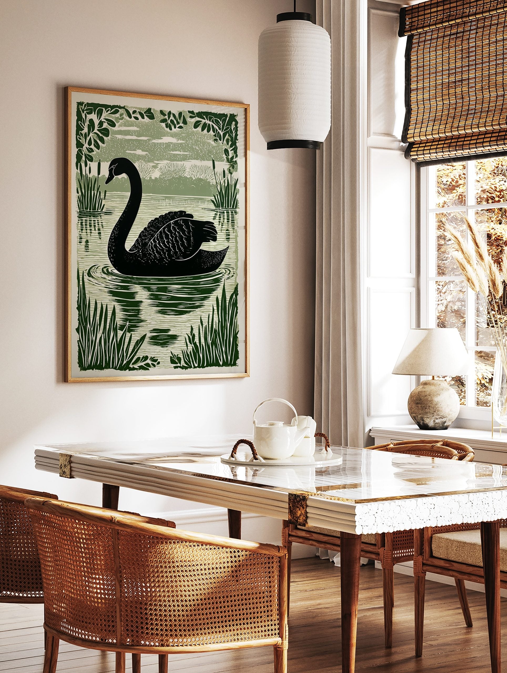 Black swan swimming in a lake, surrounded by green reeds and leafy branches in an illustrative style, in a styled room mockup