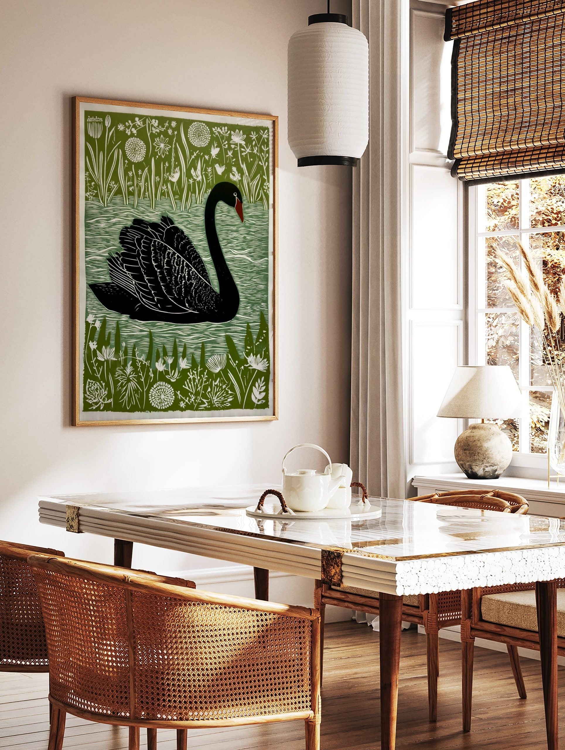 Black swan linocut style art print on green background with white botanical plants and water, in a styled room mockup