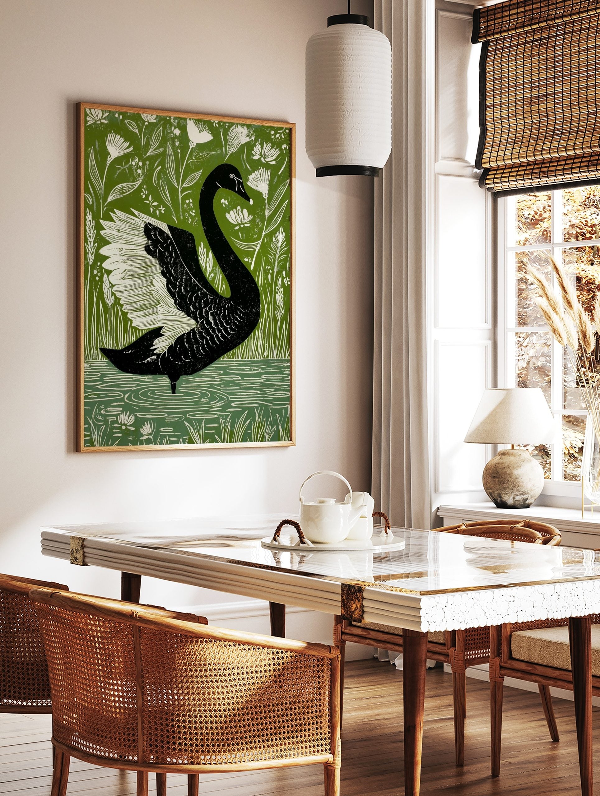 Black swan with white wings in a bold illustrative style, surrounded by green foliage and white, in a styled room mockup