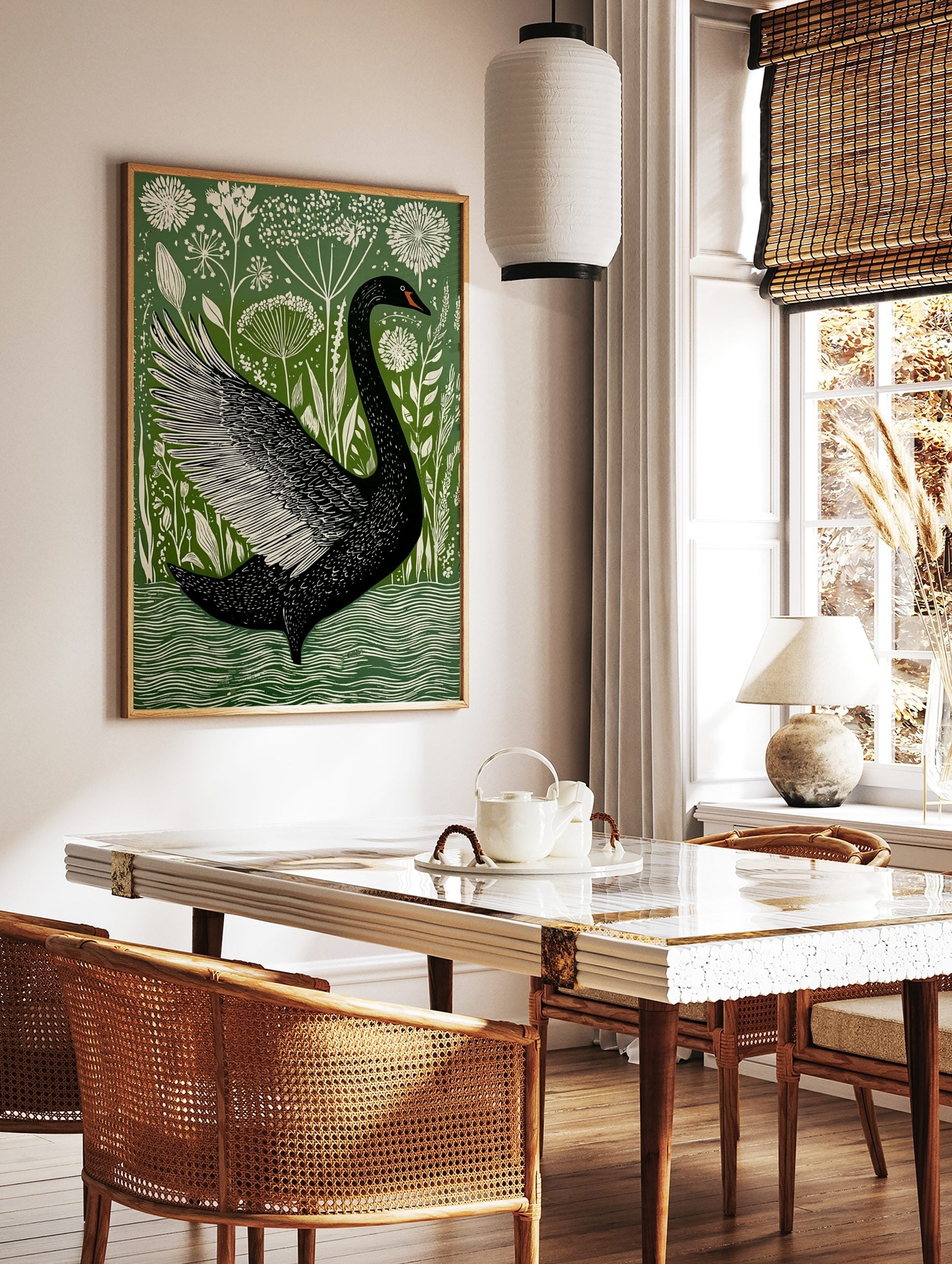 Black swan with fanned wing in illustrative green and white botanical art print, swimming in water, in a styled room mockup