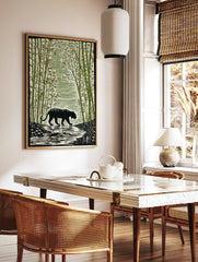 Black tiger with stripes walking through a dense green bamboo forest, river in foreground, in a styled room mockup