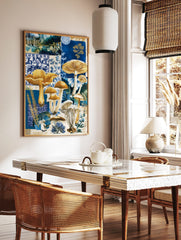 Blue and gold mushroom botanical collage art print with various fungi and patterned backgrounds, in a styled room mockup