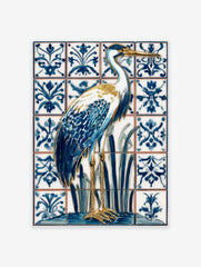 Blue and white heron bird illustration on ornate patterned tiles, with gold beak and legs